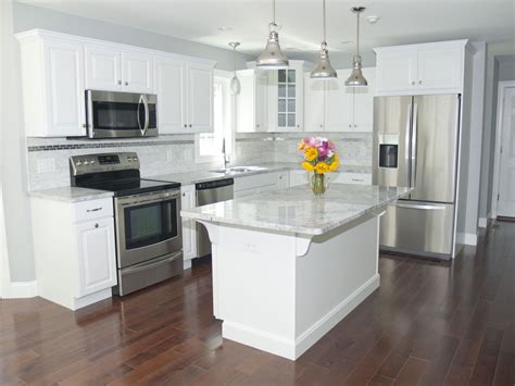 white kitchen with stainless steel appliances